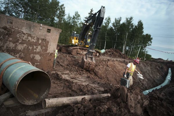 In an Aug. 21, 2017, photo, workers make sure that each section of the replacement Line 3 that is joined passes muster. Enbridge already has started b