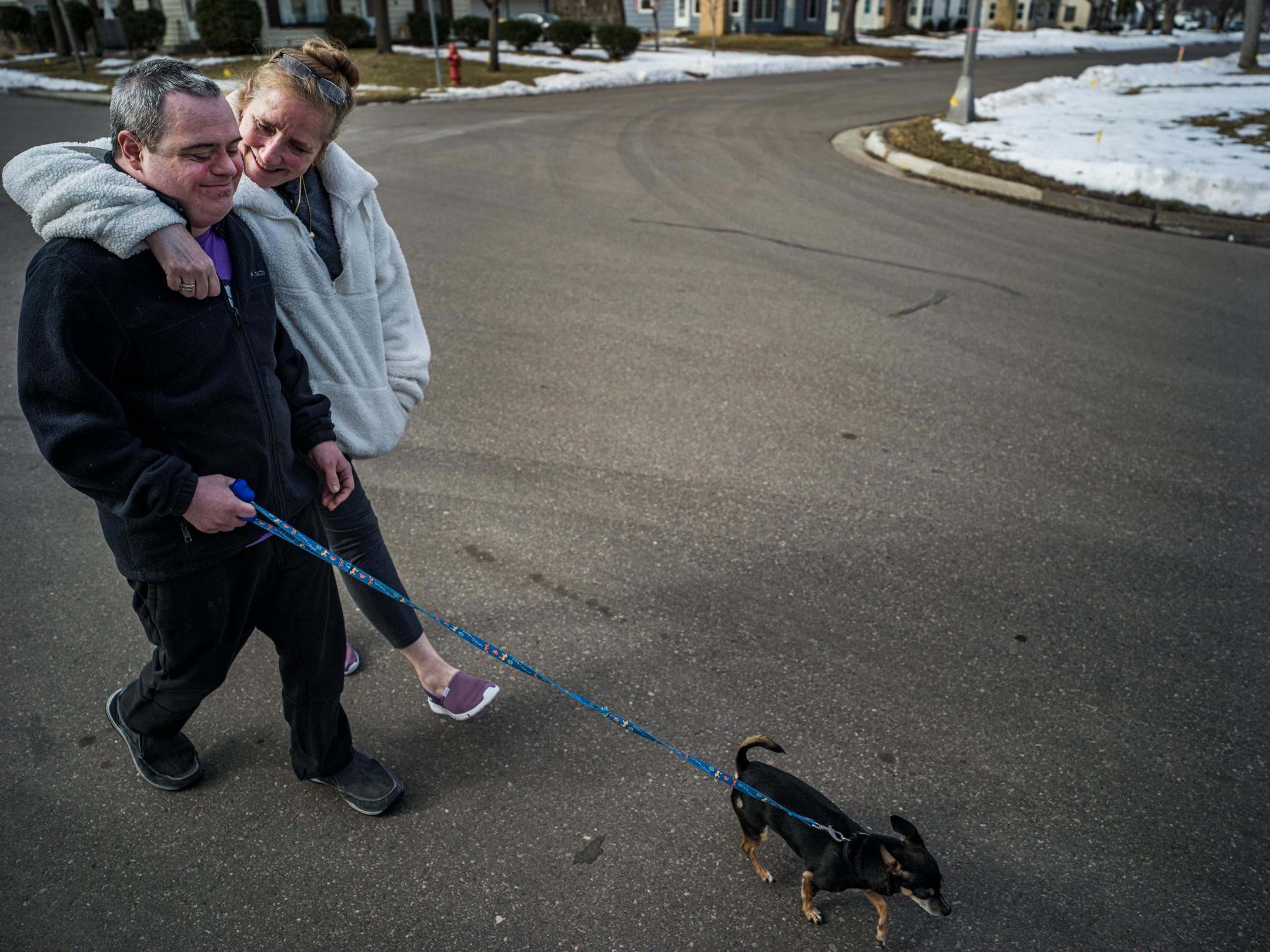 Heidi Randolph and her son, Sam Corbett, who has Down syndrome, walk around their neighborhood Wednesday, after they returned from an 8-hour trip to North Dakota to get the COVID-19 vaccine.