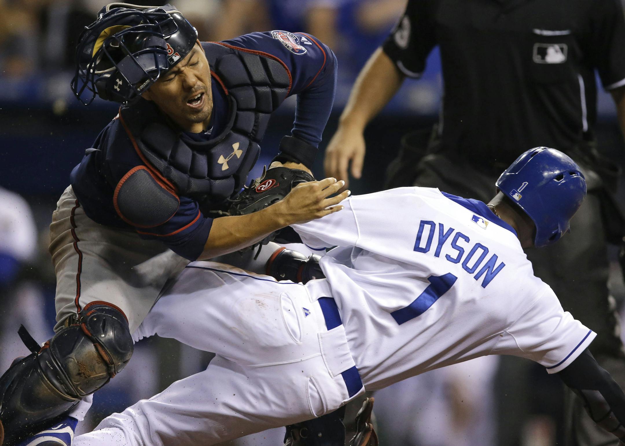 Minnesota Twins catcher Kurt Suzuki, left, tags out Kansas City Royals' Jarrod Dyson (1) during the 10th inning of a baseball game at Kauffman Stadium in Kansas City, Mo., Wednesday, Sept. 9, 2015. Suzuki was injured on the play. (AP Photo/Orlin Wagner) ORG XMIT: MIN2015090923072703