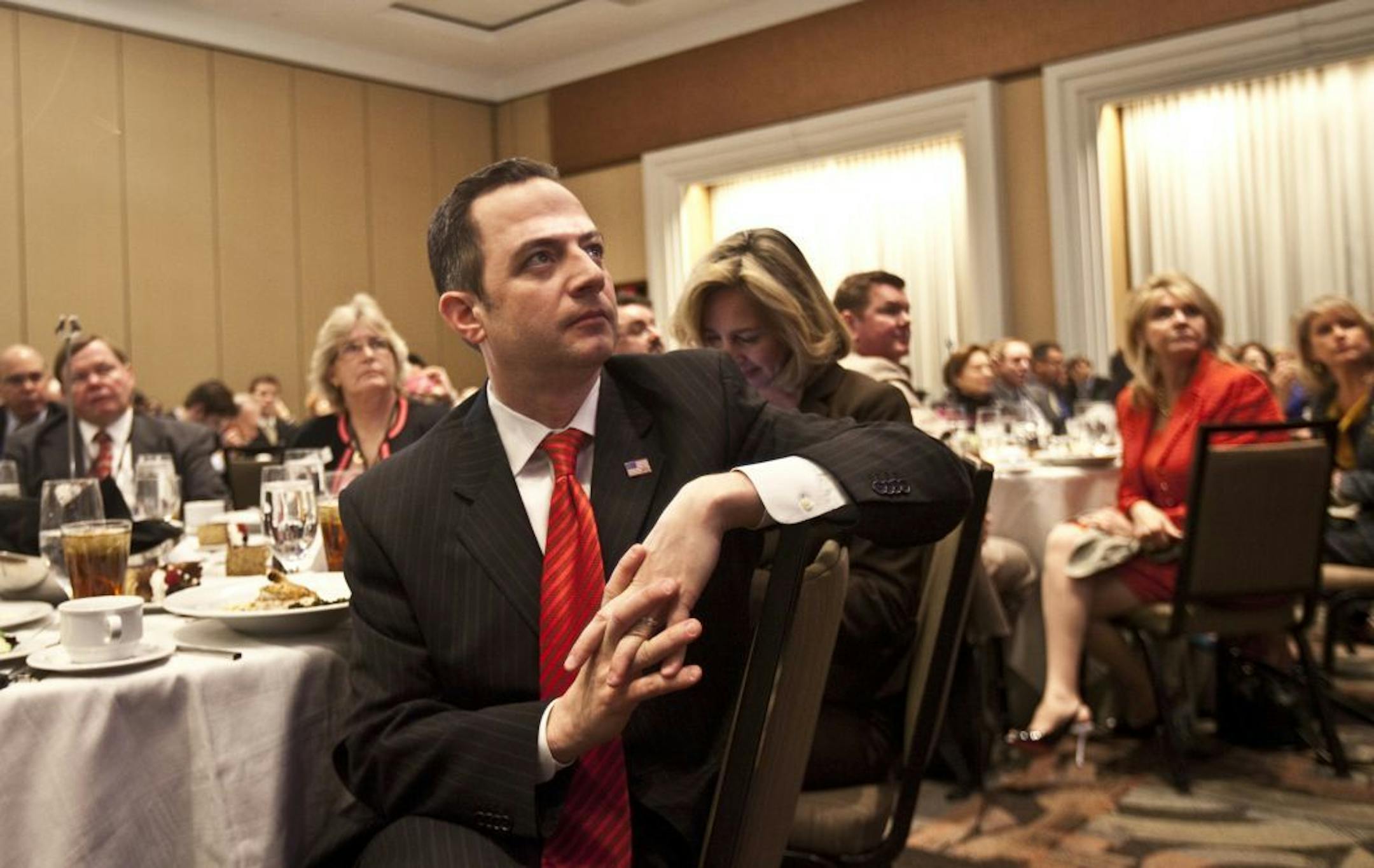 Republican National Committee Chairman Reince Preibus listens to former House Speaker Newt Gingrich speak at the RNC's annual winter meeting in Charlotte, N.C., Jan. 24, 2013. The meeeting is a moment for reviewing, rebuilding and restructuring, party officials say, but there is far from consensus for which direction Republicans should go after losing a race for the White House.