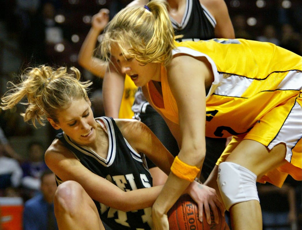 Playing for Breck, Kelly Rae Finley (right) scrapped for a loose ball during the 2003 state tournament.