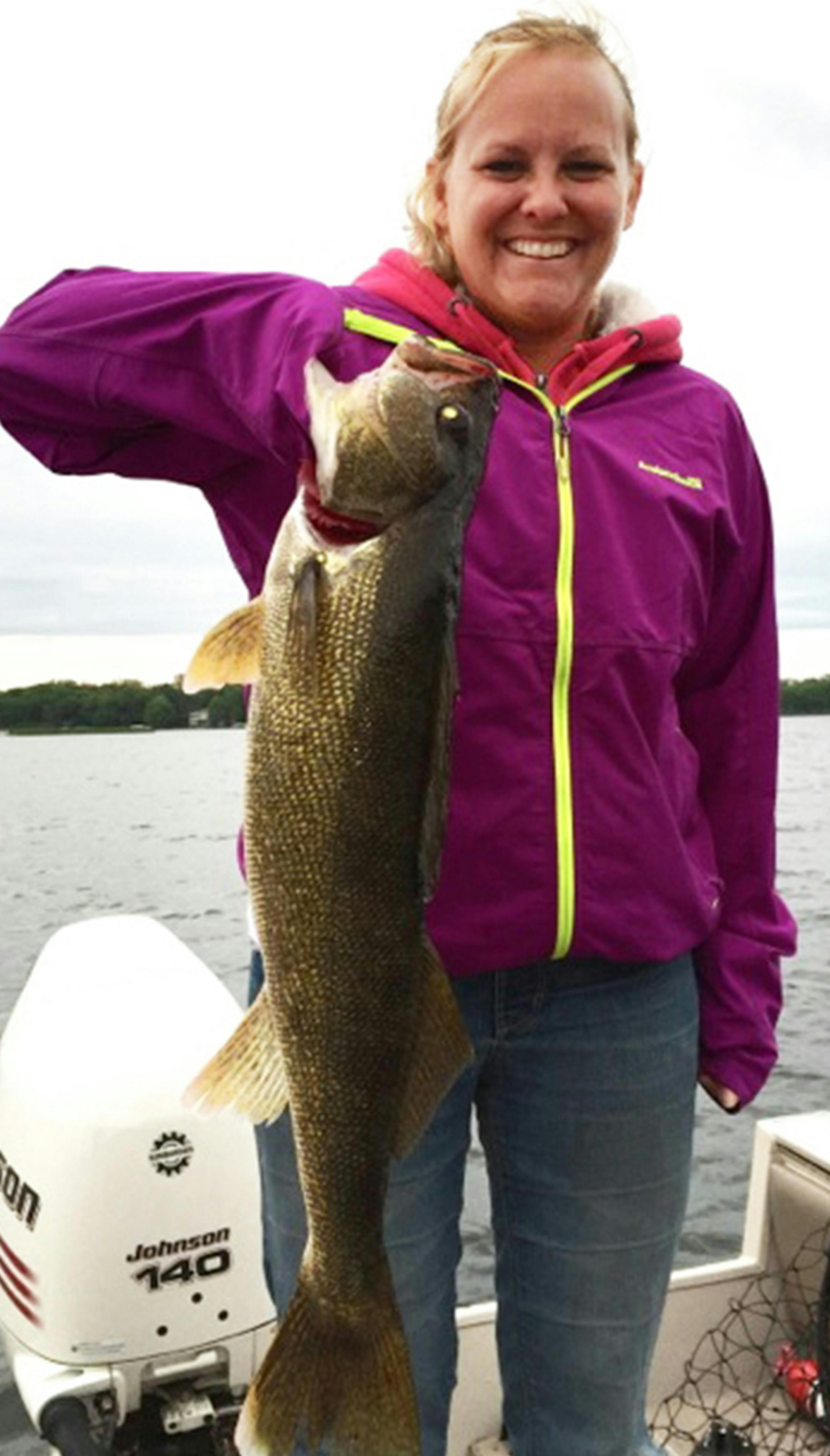NOT WEEDS Mary Lindholm of Hugo used her young daughter's fishing rod to cast off the back of the boat into White Bear Lake while her husband, Rob, fished for muskies at the bow. "She thought she went through some weeds, but the weeds tugged back,'' Rob Lindholm said. It was this 29-inch walleye. They took a photo and released the fish. "The only thing going on the wall will be the photo to always remember the day,'' Rob said.