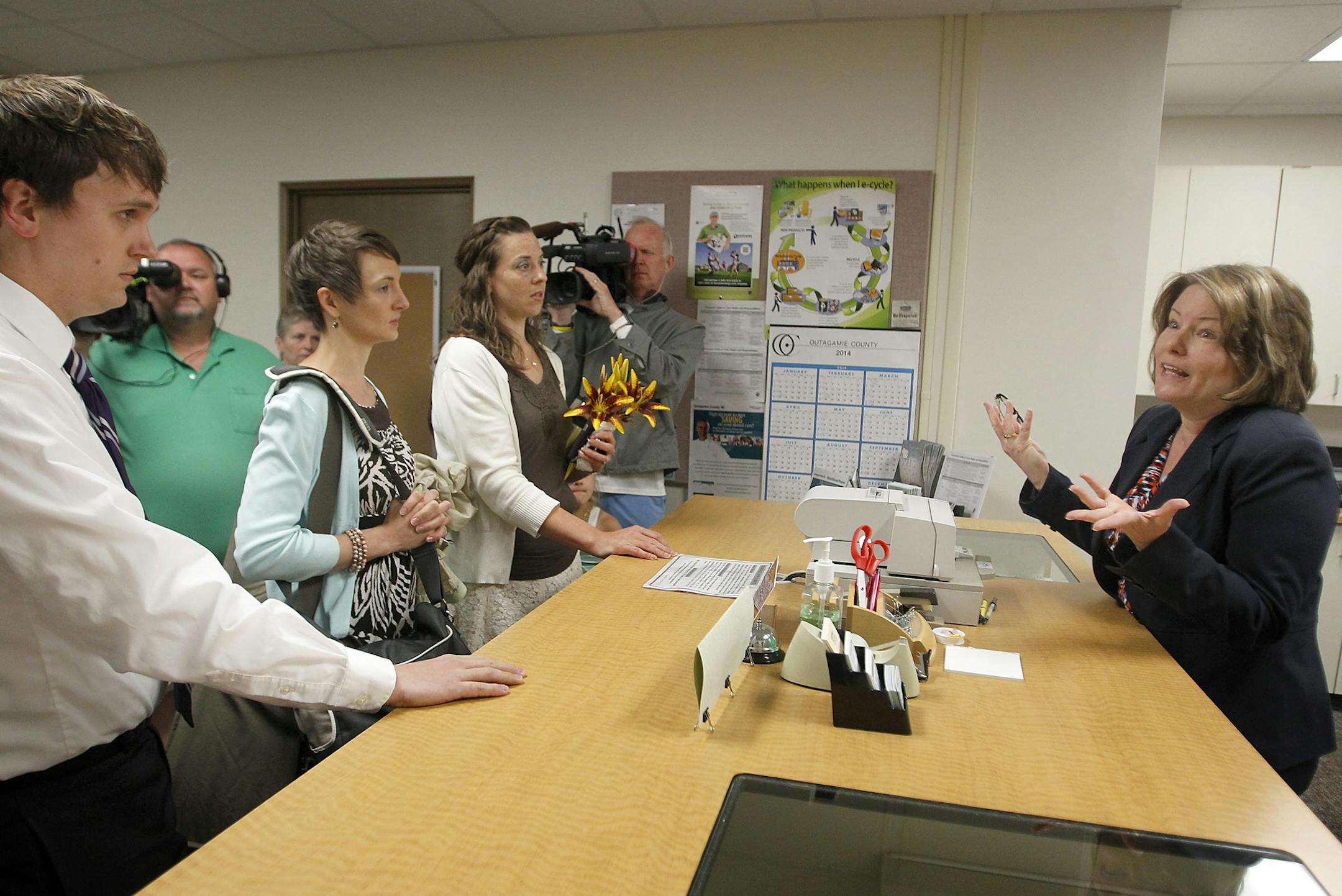 Same-sex couples and their supporters are refused marriage licenses by Outagamie County Clerk Lori O'Bright, right, on June 9, 2014 in Appleton, Wis. O'Bright said she was waiting on authorization from the state before issuing licenses. The decision was later reversed and applications for marriage licenses were accepted, subject to a five day waiting period. (AP Photo/The Post-Crescent, Wm.Glasheen) NO SALES Wm.Glasheen/Post-Crescent Media