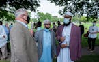 Gov. Tim Walz spoke with Imam Mohamed Mukhtar after his public remarks. ] MARK VANCLEAVE - Faith and elected leaders denounced anti-Muslim violence in