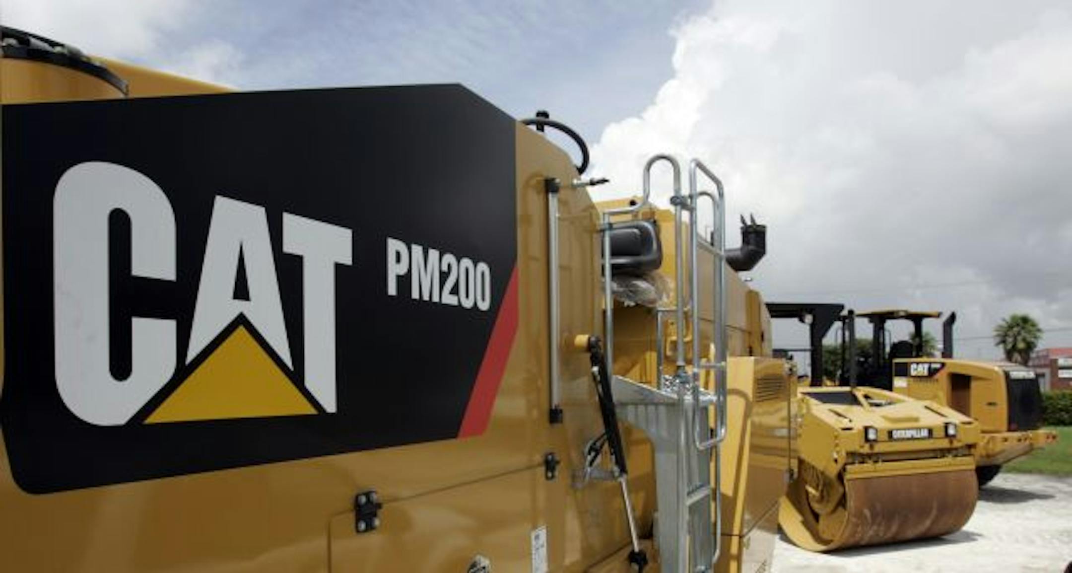 Caterpillar construction equipment, at a dealership in Miami, are on display Tuesday, July 21, 2009. Caterpillar Inc.'s second-quarter profit tumbled on slumping sales of heavy equipment and the cost of staff cuts, but it saw signs that the global economy is starting to stabilize after a prolonged slide.