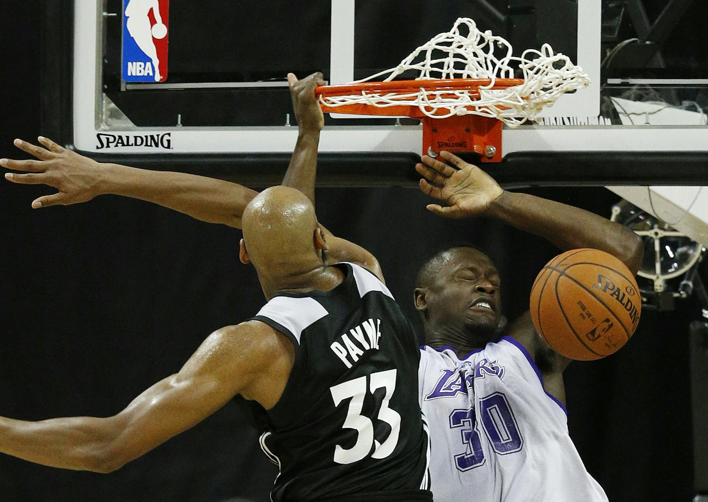 Los Angeles Lakers&#x2019; Julius Randle (30) dunks against Minnesota Timberwolves&#x2019; Adreian Payne (33) during the second half of their NBA summer league basketball game Friday, July 10, 2015, in Las Vegas. (AP Photo/John Locher)