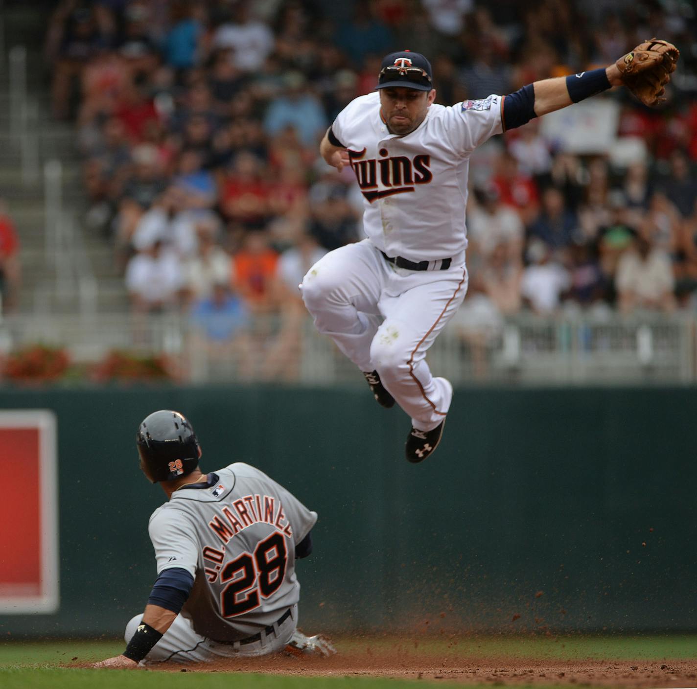 Detroit Tigers J.D. Martinez slid into 2nd base while Minnesota Twins Brian Dozier jumped above him in the second inning ] RACHEL WOOLF &#xb7; rachel.woolf@startribune.com The Minnesota Twins faced the Detroit Tigers at Target Field in Minneapolis, Minn., on Sunday July 12, 2015. The Twins beat the Tigers 7-1.