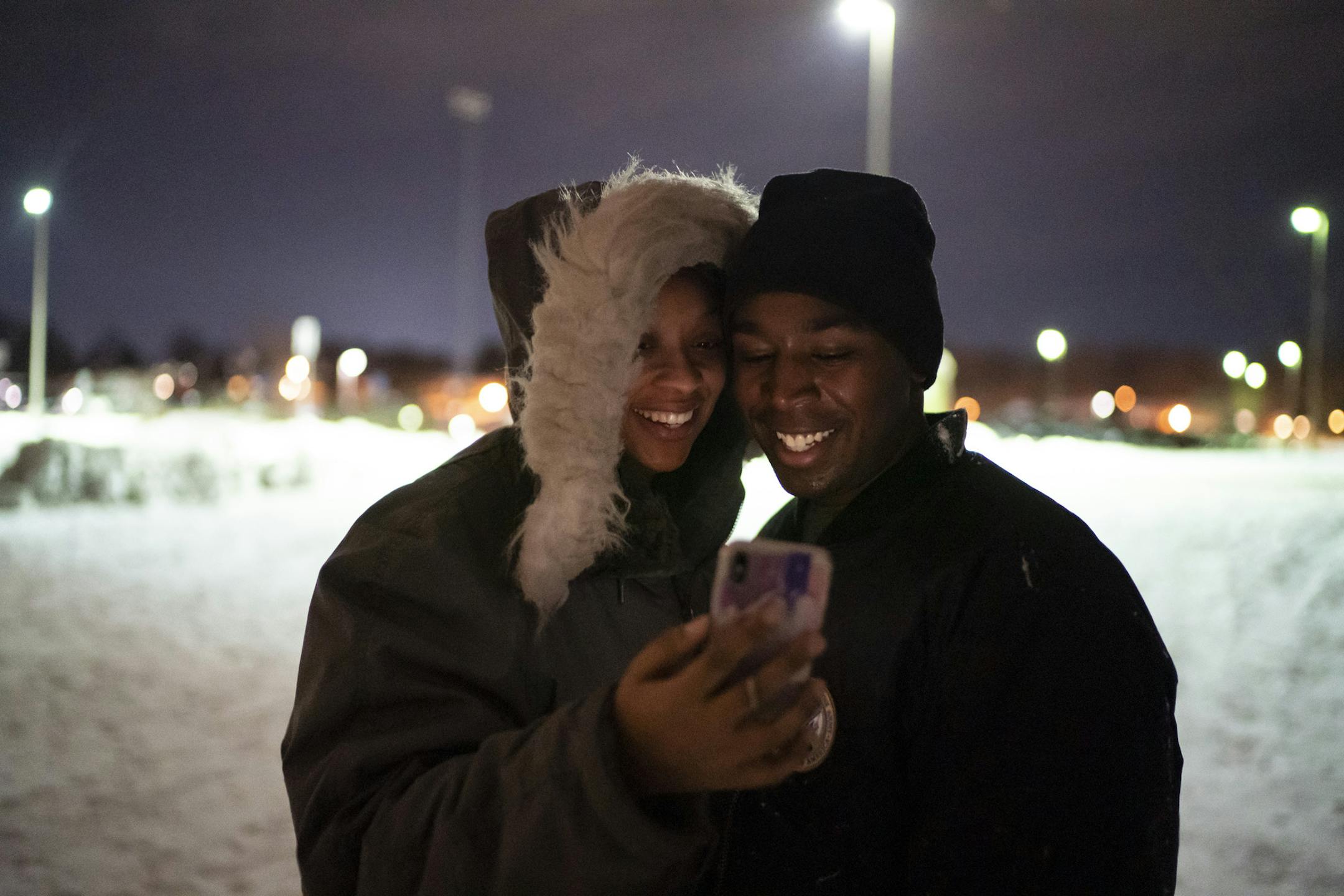 Ja'Mira Haynes cozied cup to her husband Deonte Haynes as they watched a video message from her grandma as they went sledding as a family the night before Deonte had to return to Fort Hood, Texas after a Thanksgiving break before he travels to the Middle East as a helicopter mechanic in the Army National Guard. ]in St. Paul, Minn., on Monday, December 2, 2019. ] RENEE JONES SCHNEIDER &#xa5; renee.jones@startribune.com