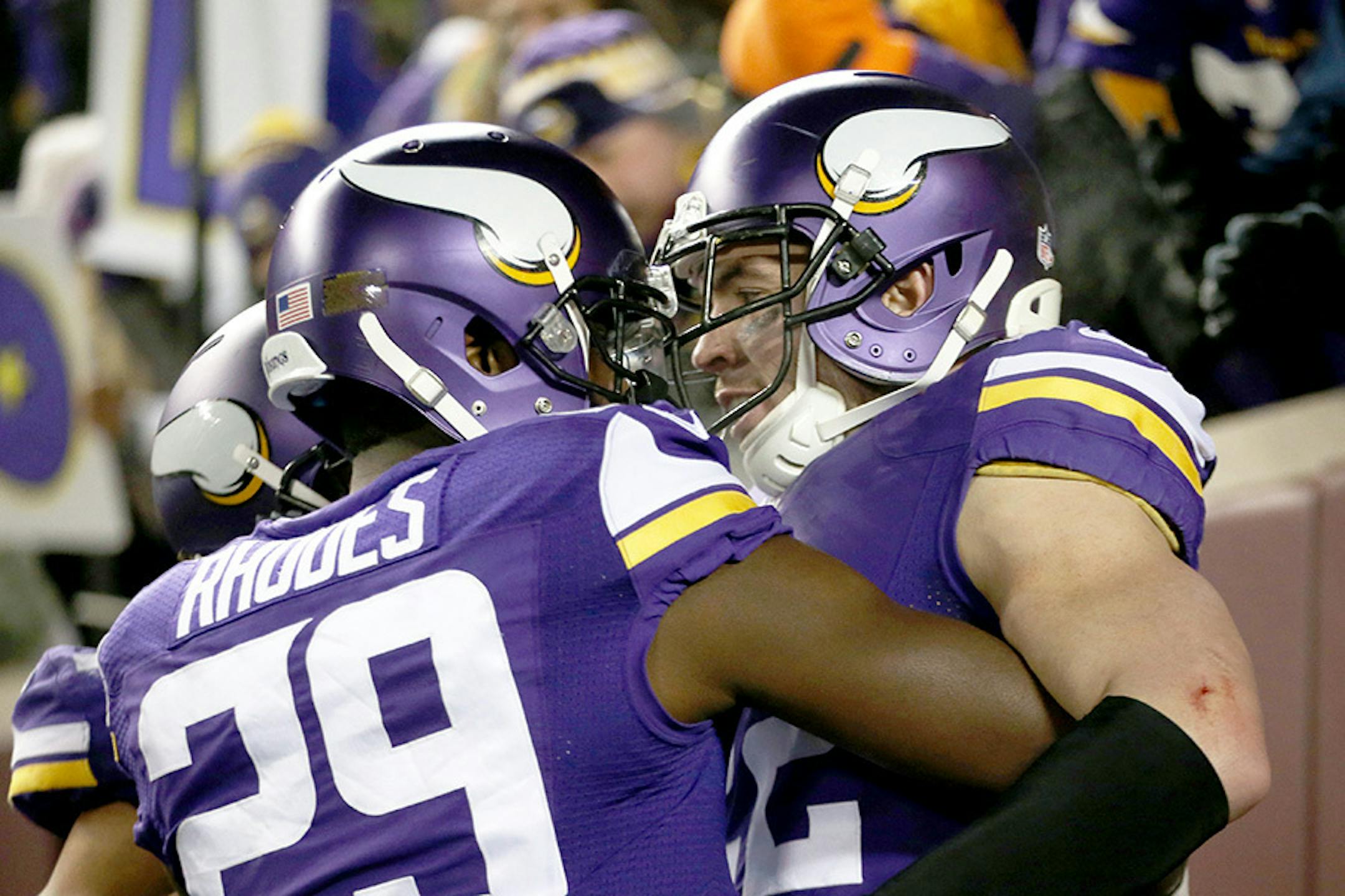Vikings cornerback Xavier Rhodes embraces safety Harrison Smith after Smith ran 35 yards for a second quarter touchdown after intercepting a pass from Giants quarterback Eli Manning.