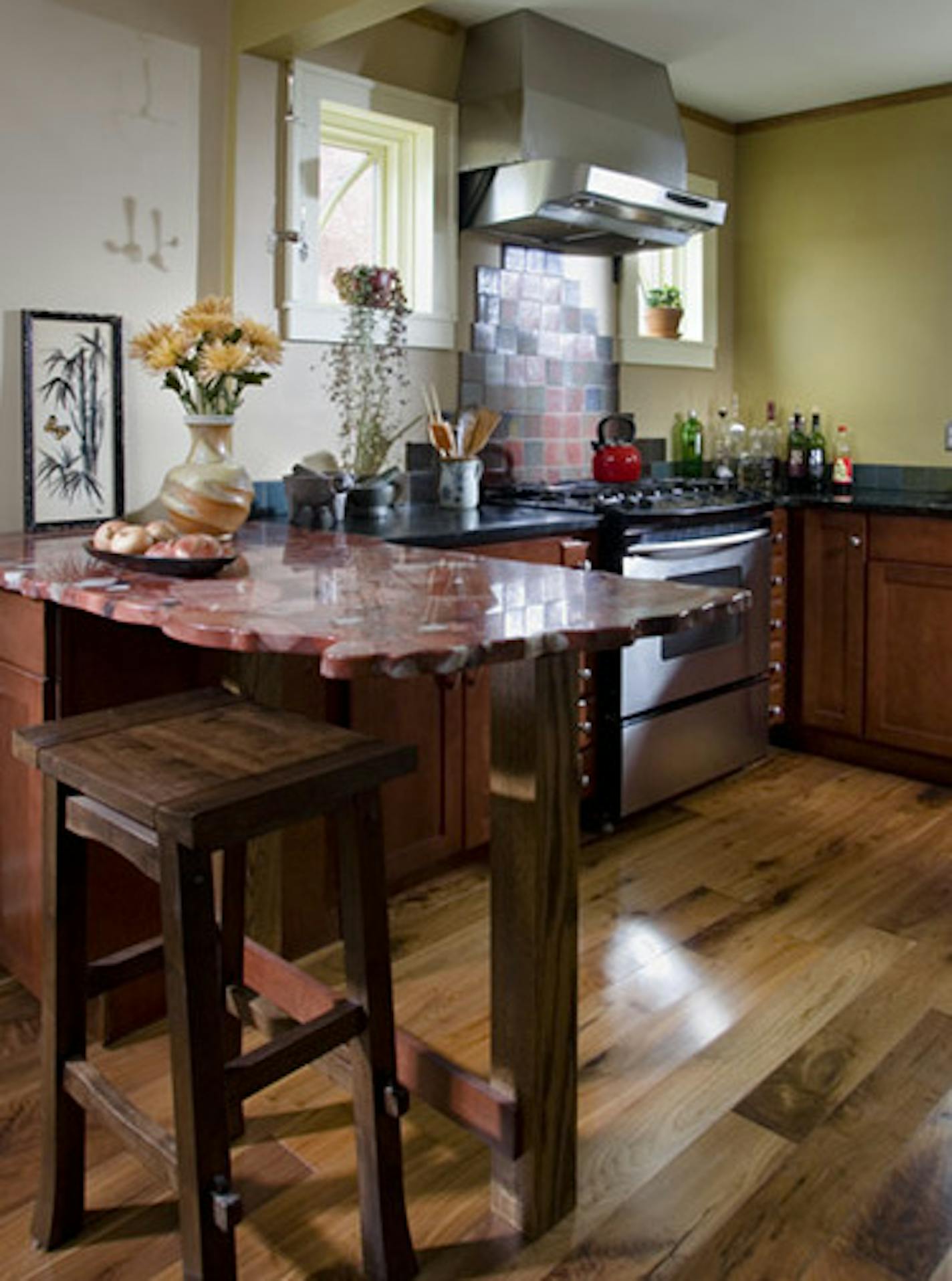 Green remodel by Michael Anschel for sale. Kitchen with Asian accents and red granite countertop. Credit Andrea Rugg