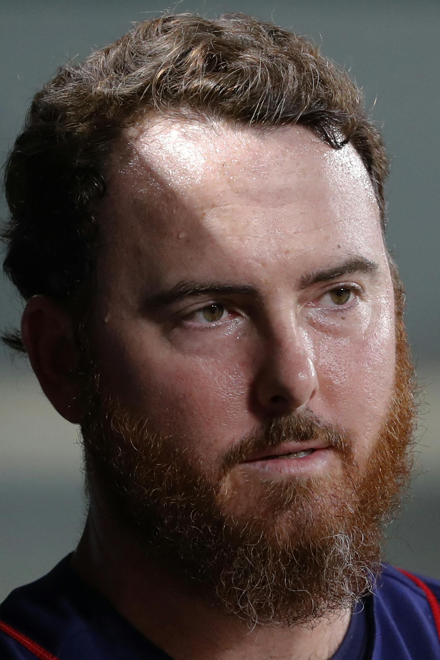 Minnesota Twins relief pitcher Sam Dyson walks through the dugout during a baseball game against the Texas Rangers in Arlington, Texas, Friday, Aug. 16, 2019. (AP Photo/Tony Gutierrez)