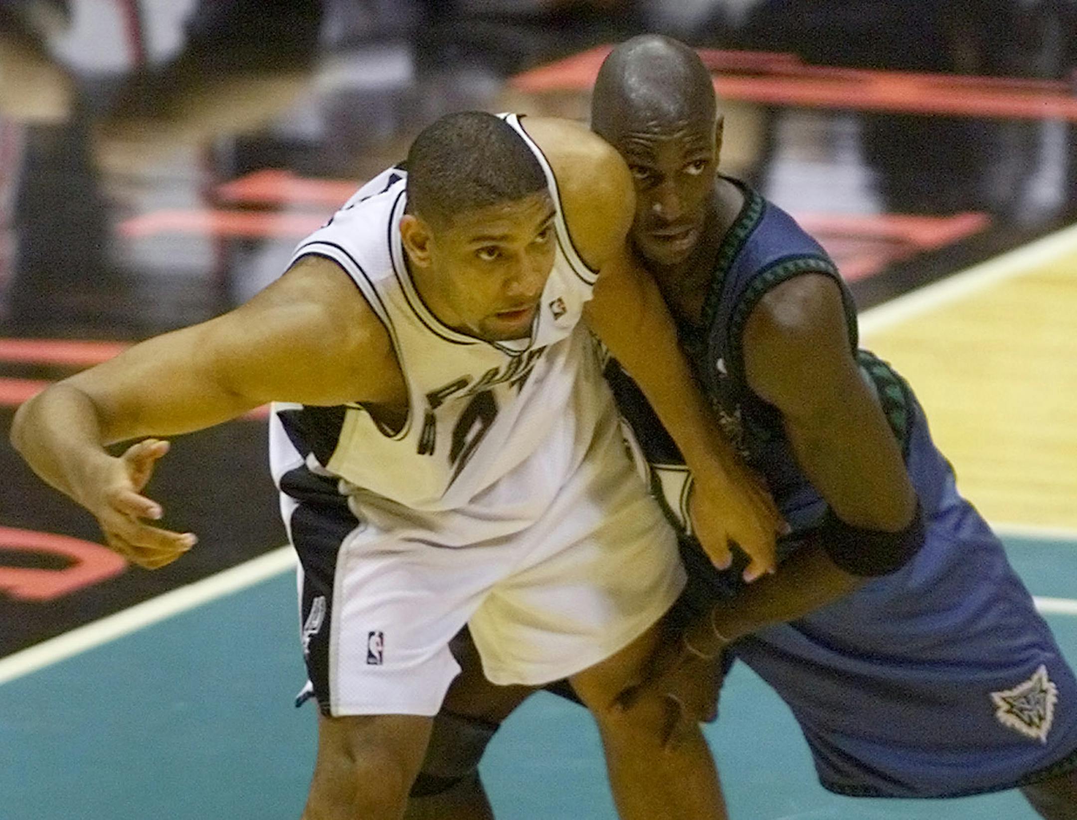 Tim Duncan and Kevin Garnett fight for position in a playoff game at the Alamadome in 1999.