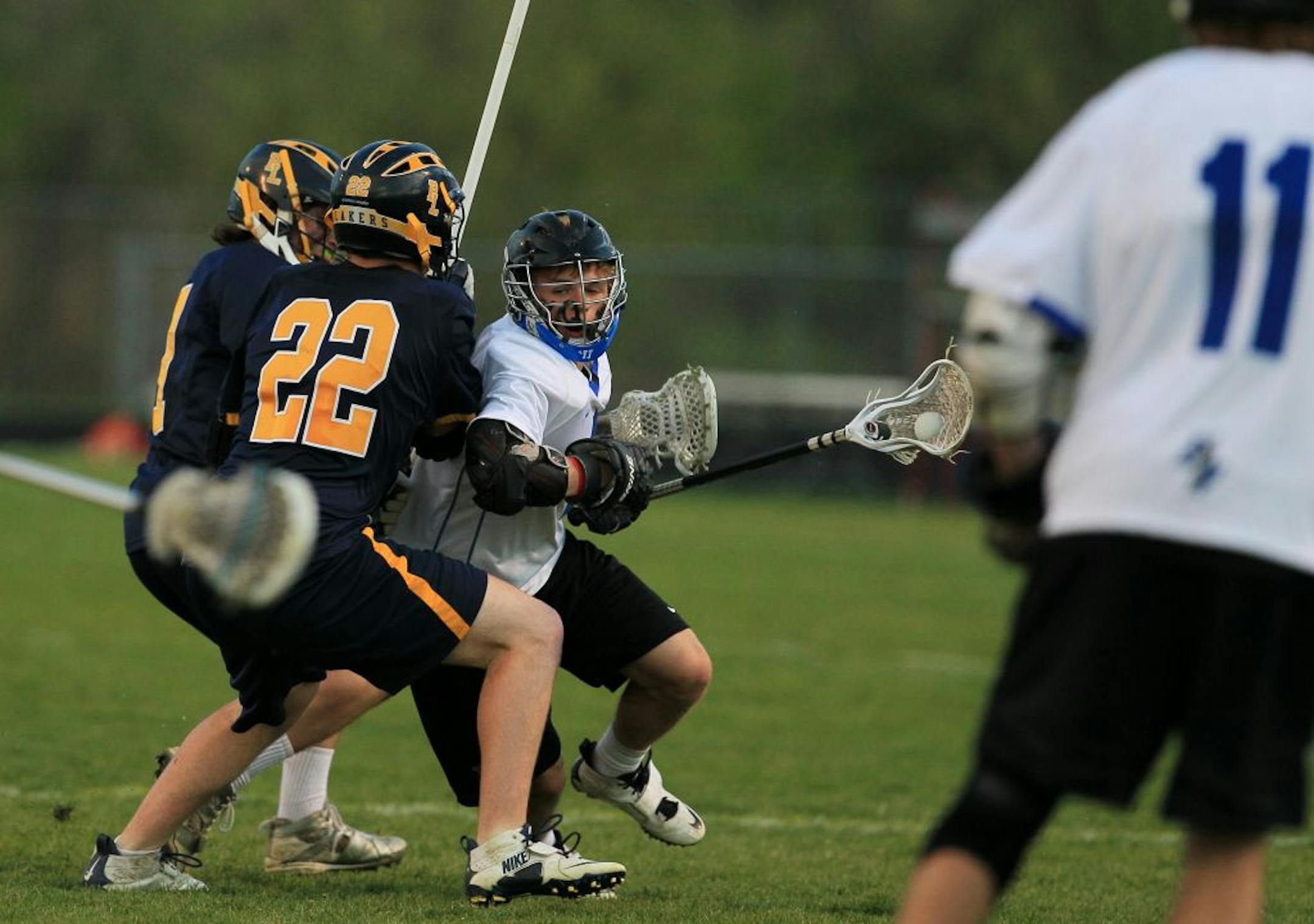 Eastview's Ryan McNamara, center, pushed past Prior Lake's Zach Pentron (22) and Eric Ambroz in a recent game at Eastview High School. Photo by Renée Jones Schneider reneejones@startribune.com