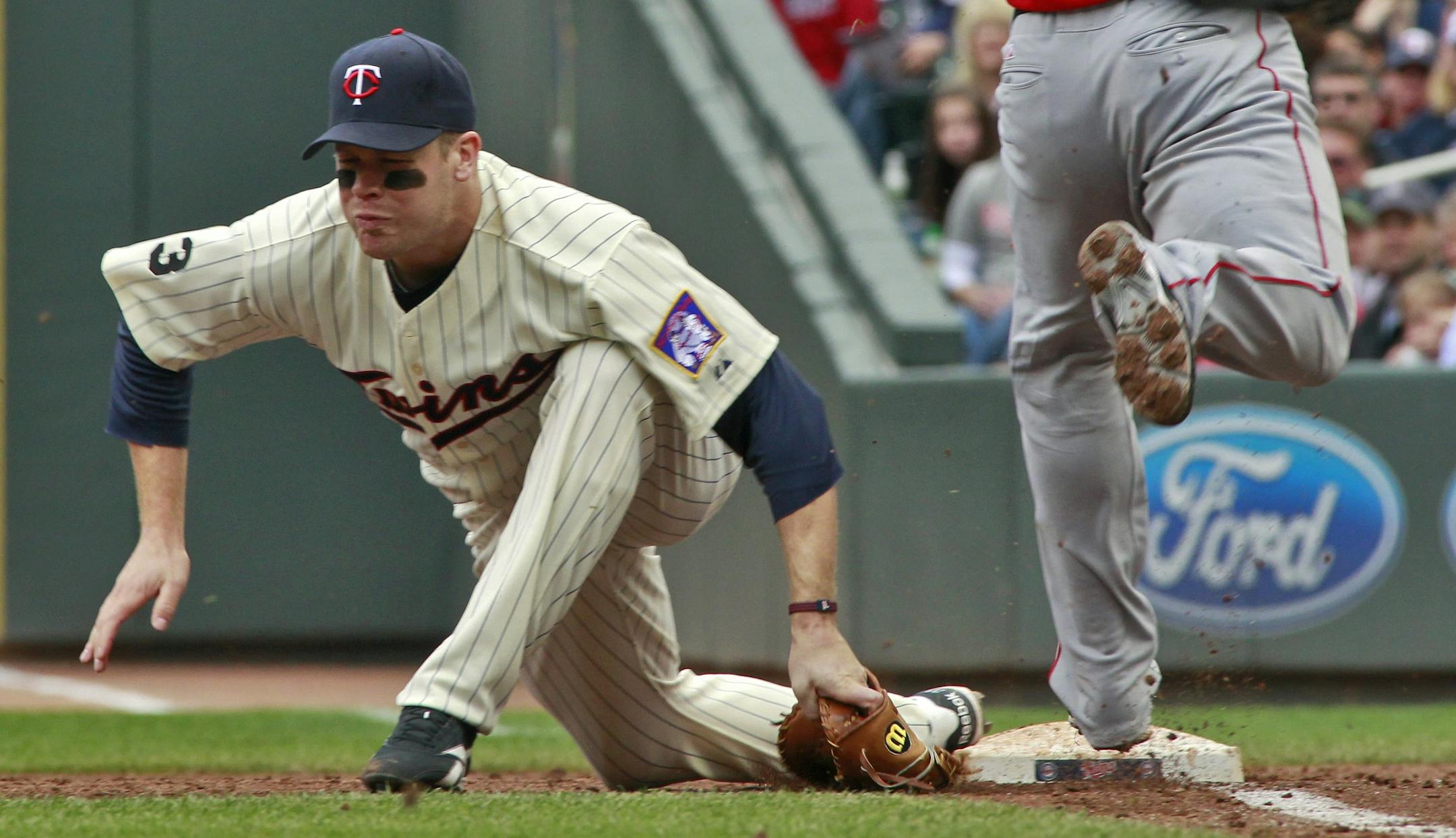 Twins first baseman Justin Morneau was unable to come up with a throw in the dirt by third baseman Danny Valencia, allowing the Angels' Jeff Mathis to reach base.