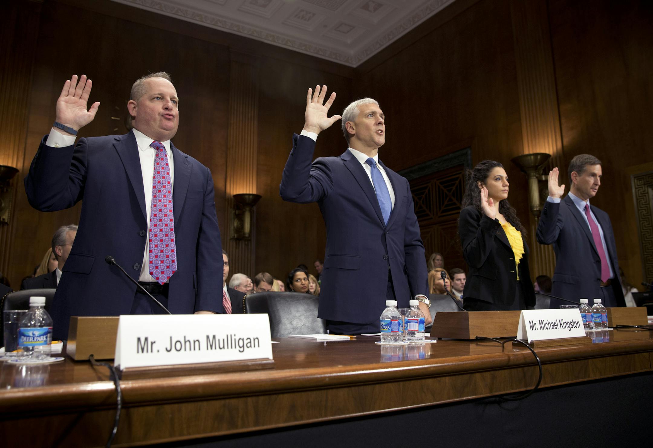 Executives including, from left: John Mulligan of Target, Michael Kingston of Neiman Marcus, Delara Derakhshani of the Consumers Union and Fran Rosch of Symantec take the oath before the Senate Judiciary Committee on Capital Hill in Washington, Jan. 4, 2014. The hearing focused on preventing data breaches and cybercrime and comes amid reports of consumers using more cash instead of plastic in the wake of credit card data security breaches.(Stephen Crowley/The New York Times)