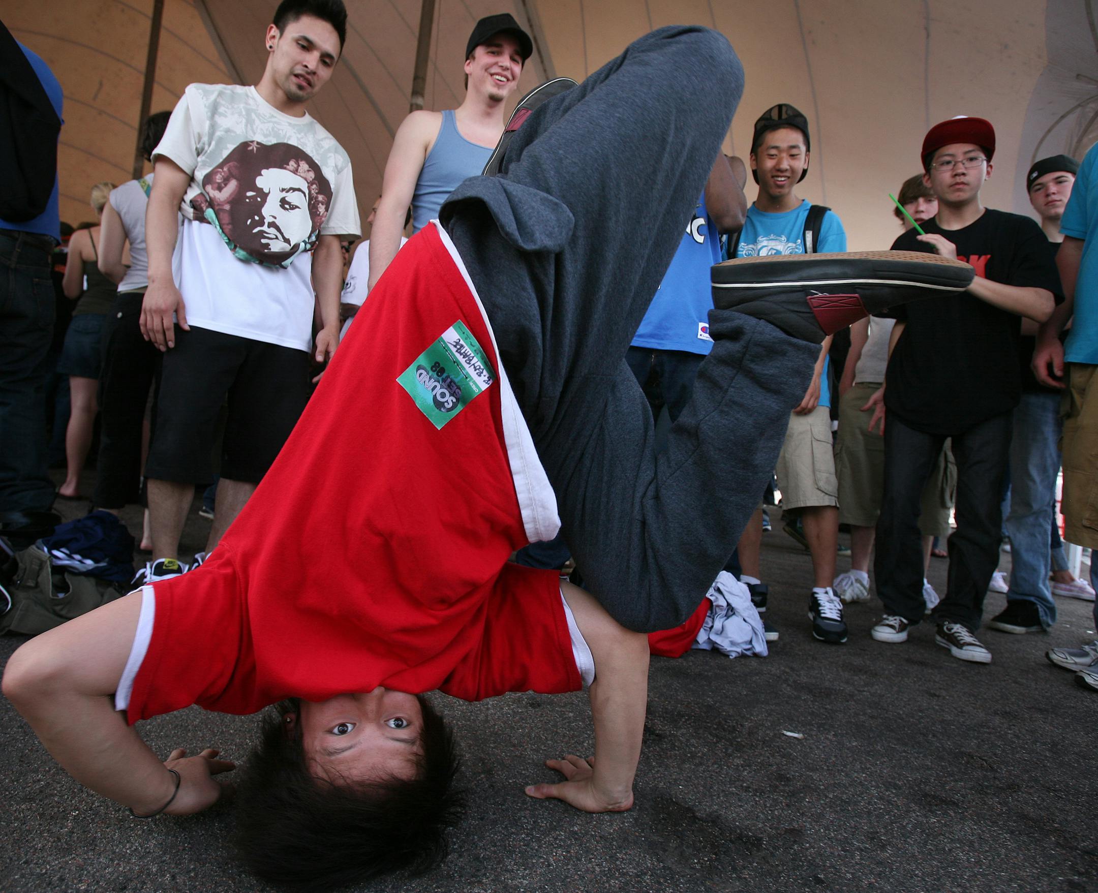Matthew Xiong, 17, of Brooklyn Park did a head stand as he jammed to the beat in the B-Boy battle at the Soundset music festival Sunday in the Metrodome parking lot. The show was sponsored by local rap label Rhymesayers.