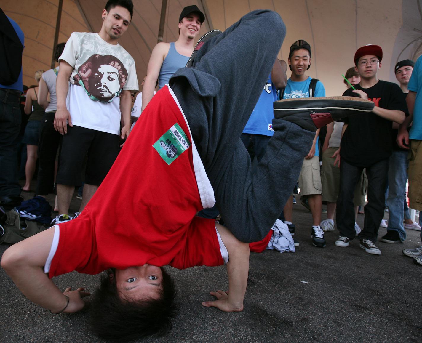 Matthew Xiong, 17, of Brooklyn Park did a head stand as he jammed to the beat in the B-Boy battle at the Soundset music festival Sunday in the Metrodome parking lot. The show was sponsored by local rap label Rhymesayers.