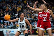 Hannah Stuelke eludes two Cornhuskers players en route to 25 points and a Big Ten crown. Stuelke was one of the players that kept Iowa in the game eve
