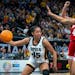 Hannah Stuelke eludes two Cornhuskers players en route to 25 points and a Big Ten crown. Stuelke was one of the players that kept Iowa in the game eve