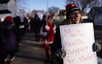 Music teacher Mackenzie Henson held a sign as she and fellow members of the St. Paul Federation of Educators braved the frigid temperatures while they