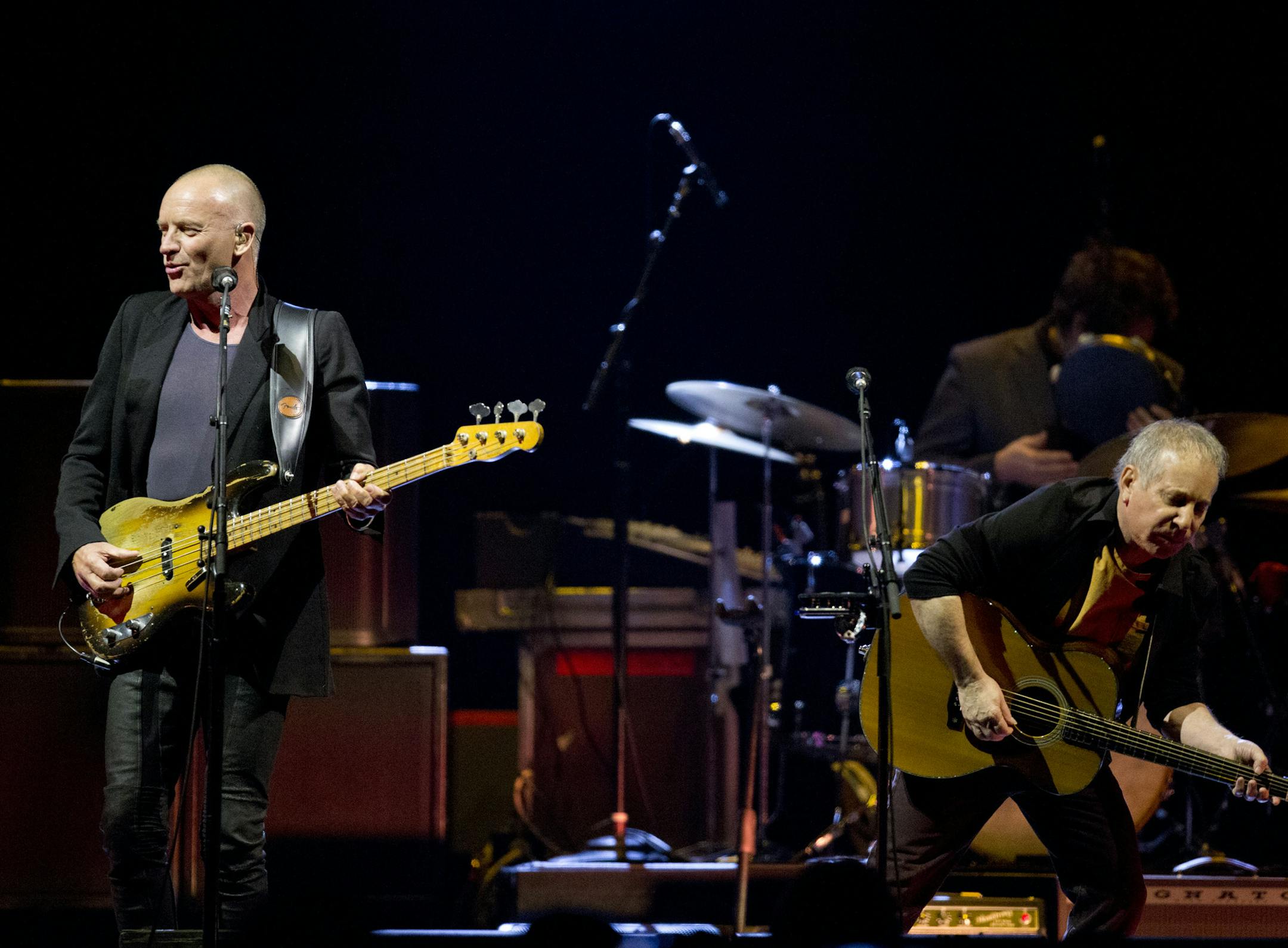 Sting, left, and Paul Simon perform at the Xcel Energy Center in St. Paul on Feb. 23, 2014.