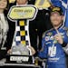 Dale Earnhardt Jr poses with the trophy in Victory Lane after winning the first of two qualifying races for Sunday's NASCAR Daytona 500 Sprint Cup ser