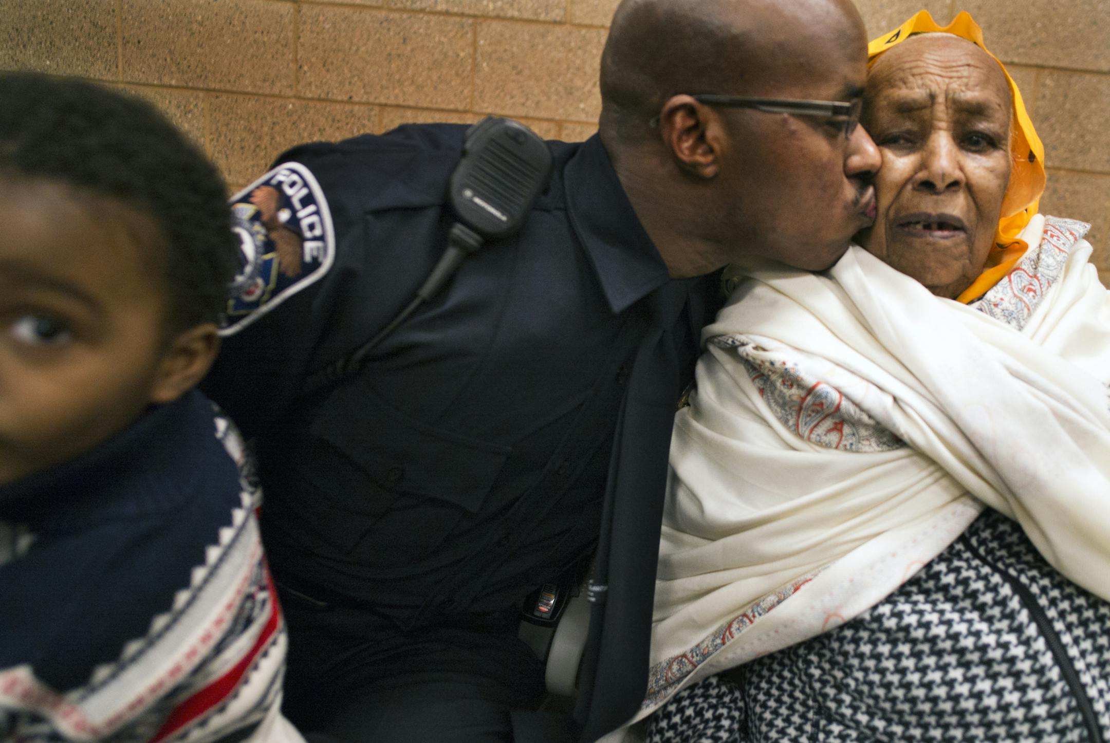 Columbia Heights police's first Ethiopian officer Hashim Abdullahi kissed his grandmother, Kemero Keiro. On the left was Abdullah's nephew Tamir, 4.] Richard Tsong-Taatatarii@startribune.com