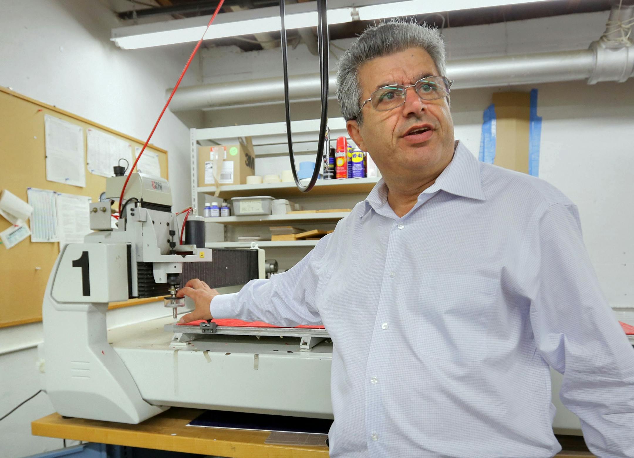 Reuven Rahamim, of Accent Signage in Minneapolis, with a machine he invented for putting Braille lettering on signage. Rahamim, 61, was shot to death at Accent Signage Systems Inc., in Bryn Mawr, by a fired employee.