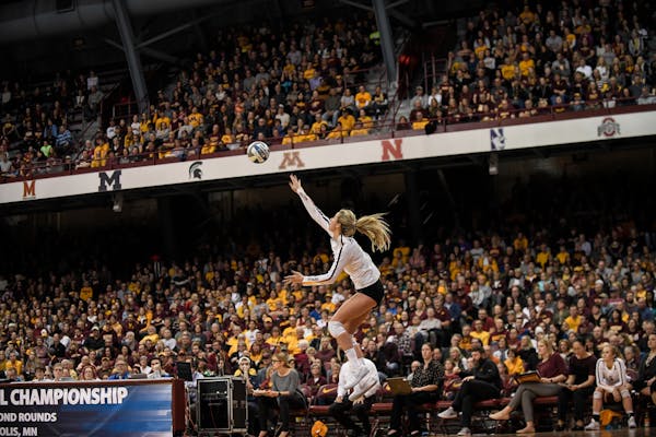 Minnesota setter Samantha Seliger-Swenson (11) served the ball in the fourth set Saturday night against the University of Northern Iowa. ] AARON LAVIN