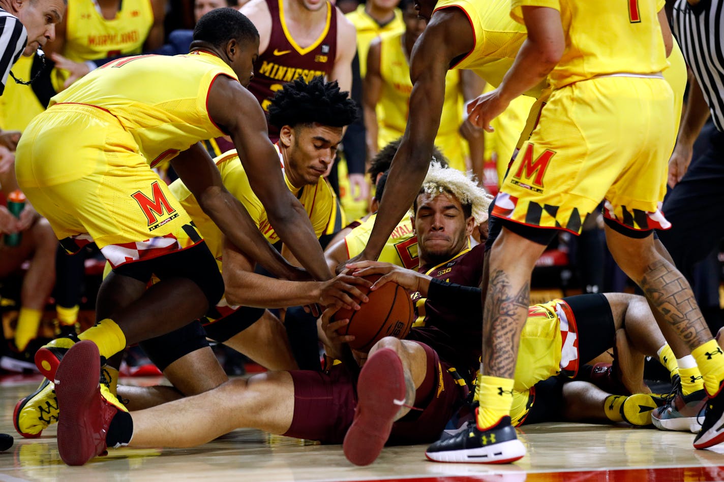 Gophers forward Jarvis Omersa tried to keep possession as he was surrounded by Maryland players in the first half Friday night.