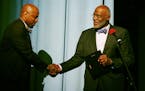 Justice Alan Page right shook hands with Michael Walker who leads the office of black male student achievement after he was given an award for his ser