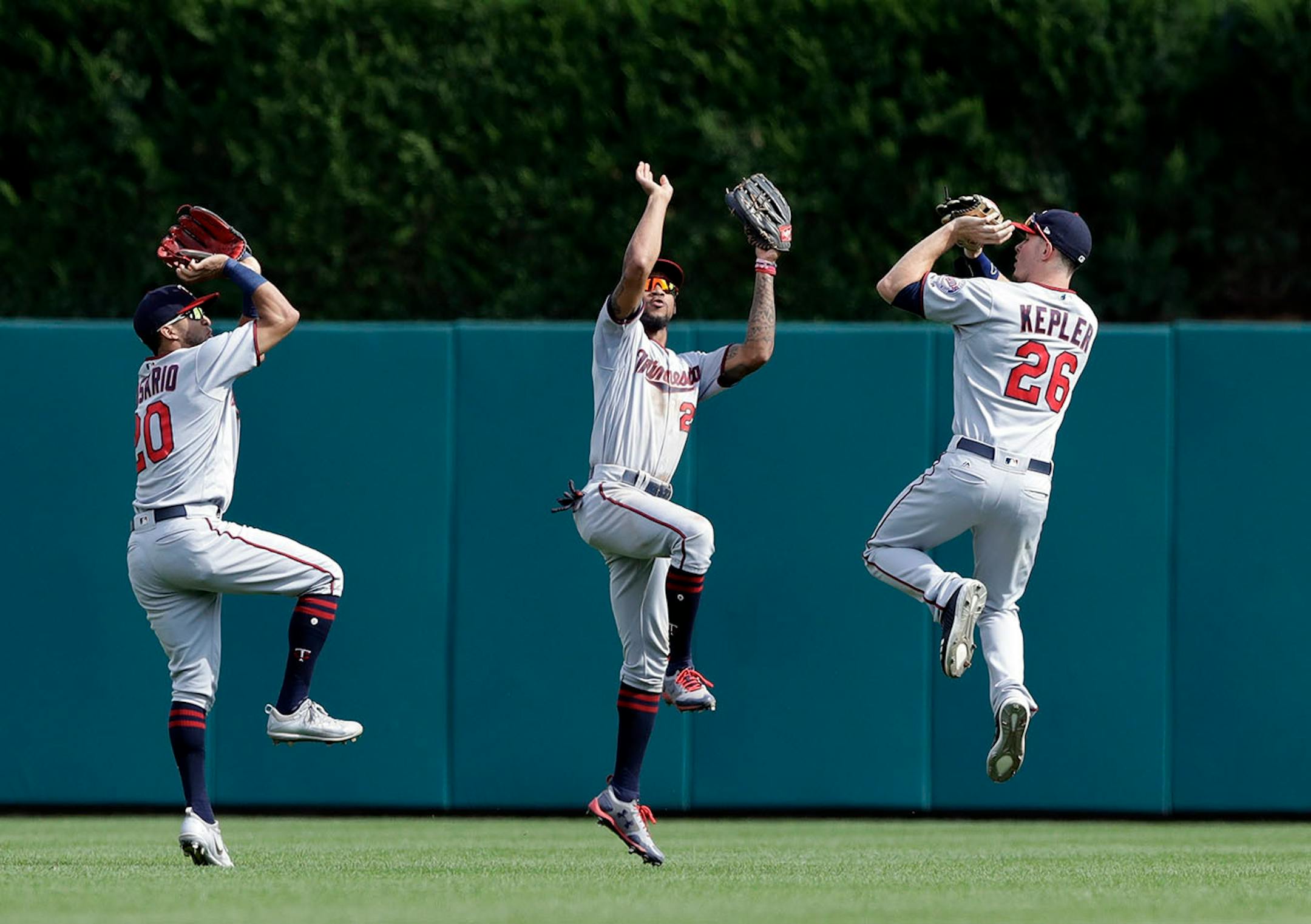 Minnesota Twins left fielder Eddie Rosario (20), center fielder Byron Buxton (25) and right fielder Max Kepler (26) celebrate the their team's 6-4 win over the Detroit Tigers in a baseball game, Sunday, Aug. 13, 2017, in Detroit.