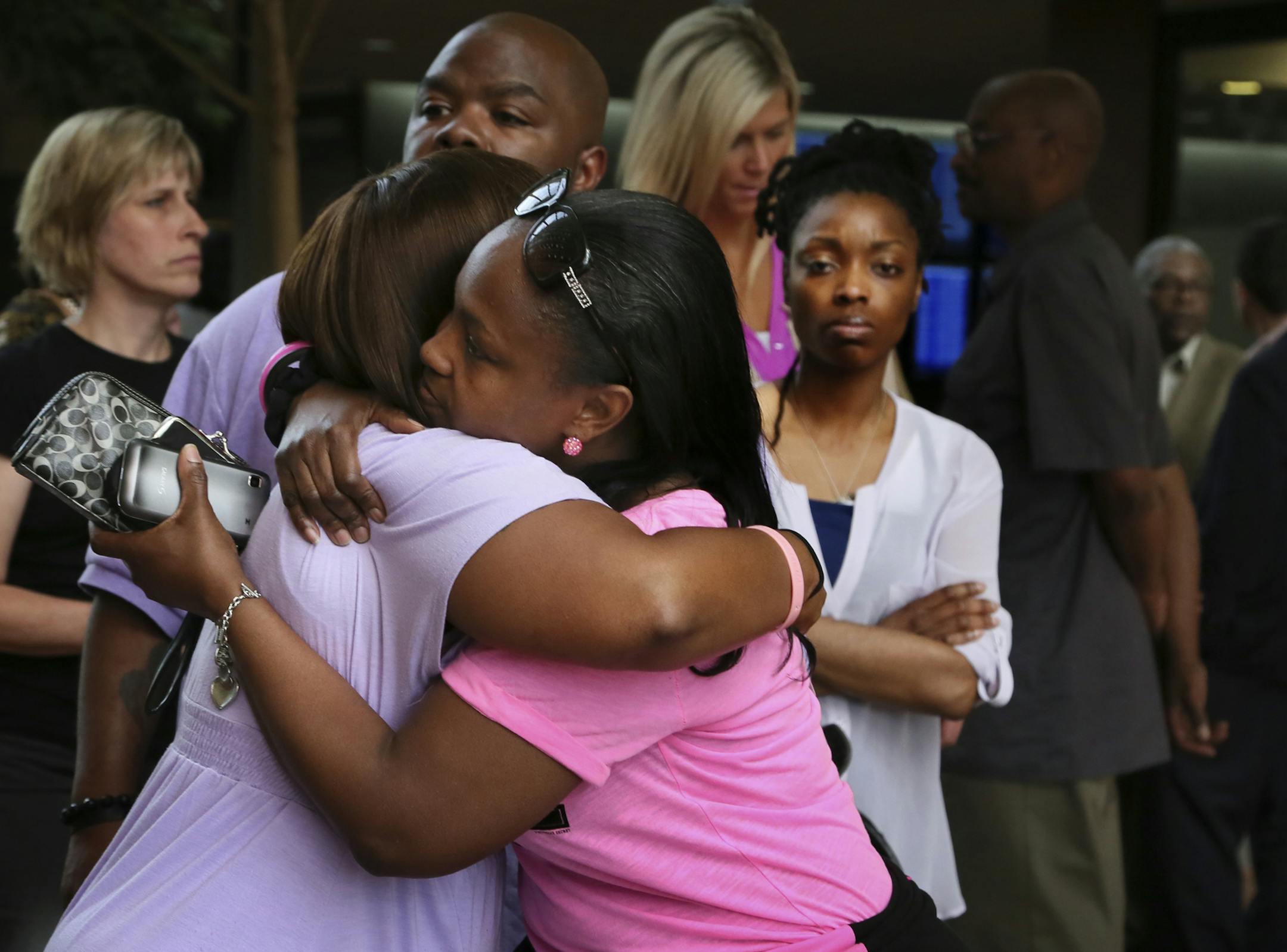 Family members of the victims embraced after a news conference Thursday at the Hennepin County Government Center following the verdict.