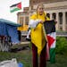 Student Eleanor Wirtz, 21, carefully folds up a Palestinian flag as she and other protesters clear the encampment at the University of Minnesota on Th