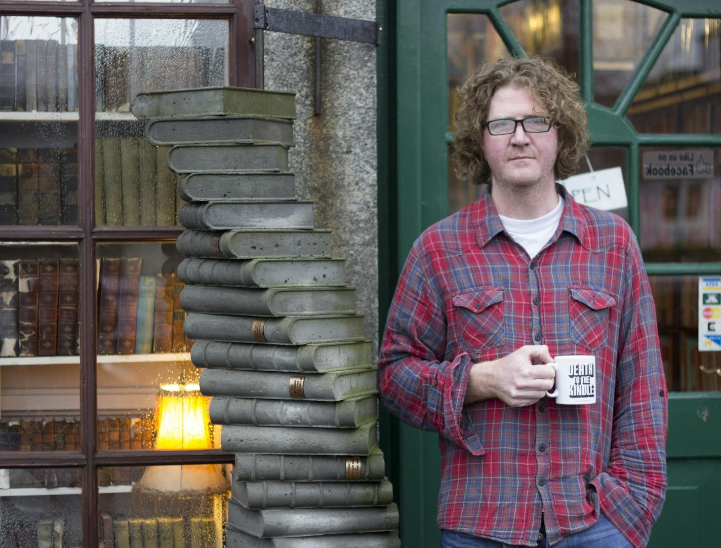 Shaun Bythell in front of his bookstore in Wigtown, Scotland. Photo by Ben Please