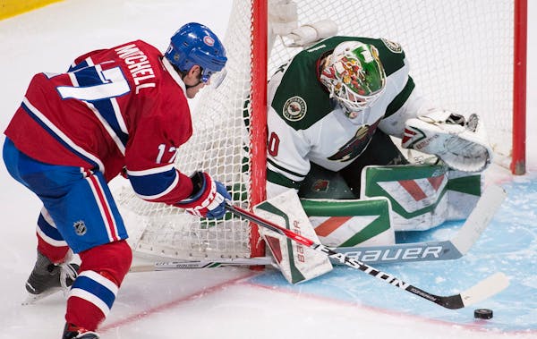 The Canadiens' Torrey Mitchell moves in on Wild goalie Devan Dubnyk during the third period in Montreal on Saturday.