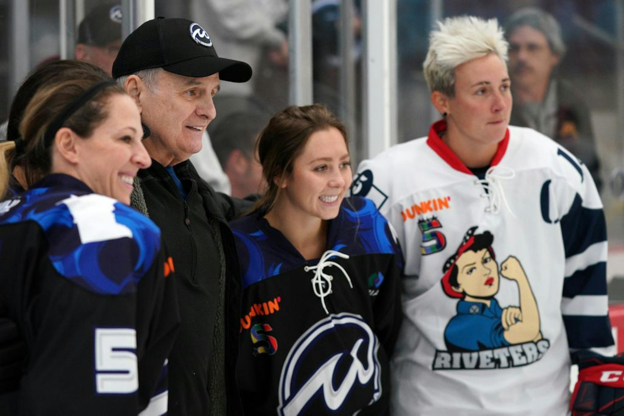 Former Gov. Mark Dayton posed for photos following a ceremonial puck drop ahead of Saturday's game.