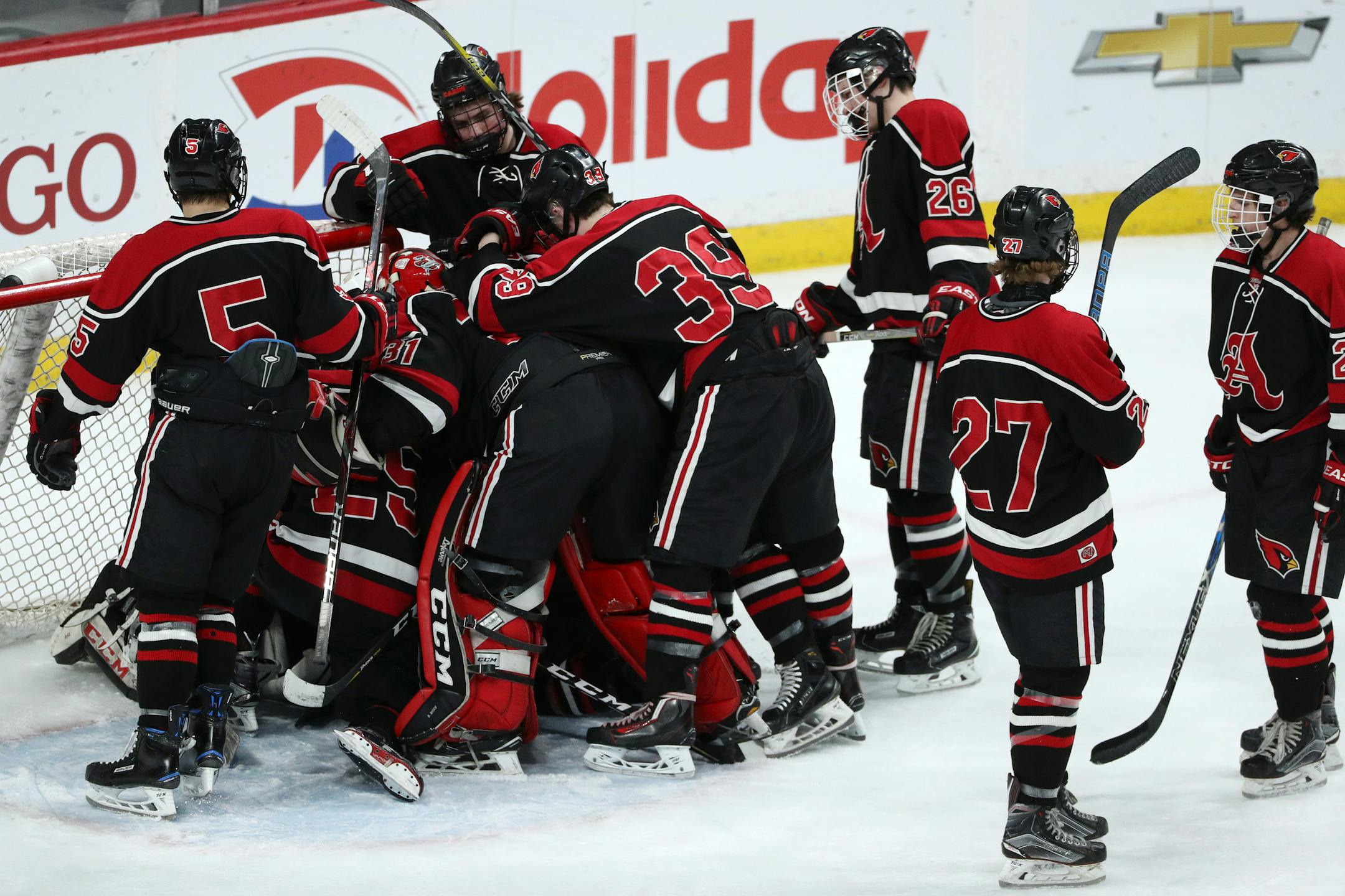 Alexandria Area High School players piled on top of Alexandria Area High School goaltender Jackson Boline (30) after the loss to Orono High School. ] ANTHONY SOUFFLE � anthony.souffle@startribune.com Alexandria Area High School played Orono High School in an MSHSL Class 1A boys hockey championship game Saturday, March 10, 2018 at the Xcel Energy Center in St. Paul, Minn.