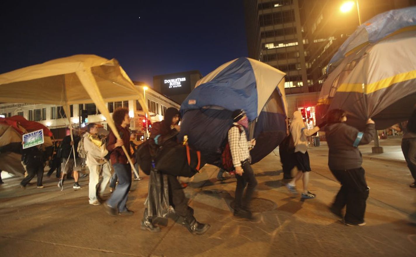 After being asked to take down their tents in Peavey Plaza Occupy participants took to the streets on Nicollet Mall during the first day back for Occupy Minnesota in Minneapolis Min., Saturday, April 7, 2012.