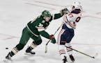 Ryan Suter (20) of the Minnesota Wild collided with Connor McDavid (97) of the Edmonton Oilers in the second period. ] CARLOS GONZALEZ &#x2022; cgonza