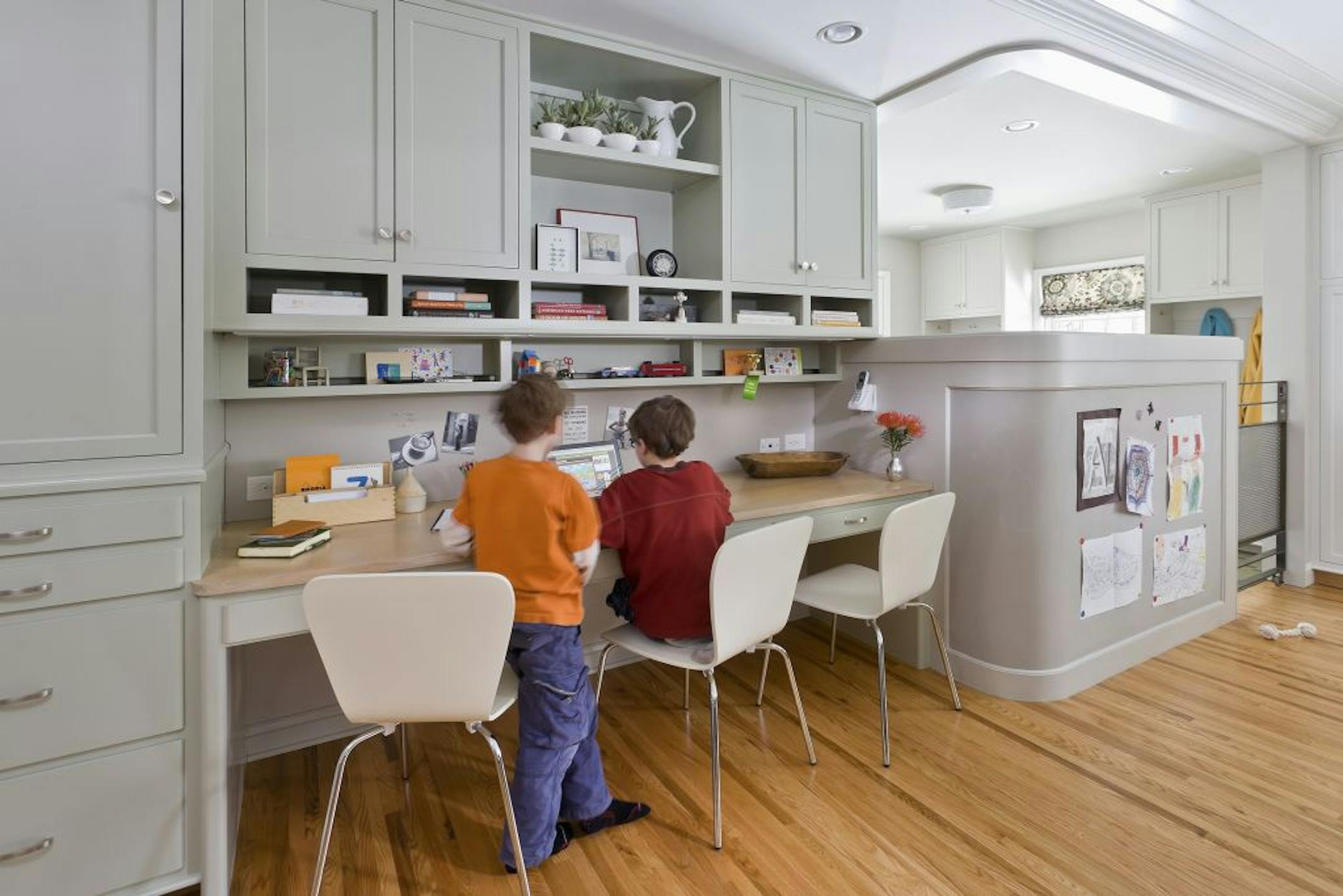 The new kitchen, designed by Rehkamp Larson Architects, includes a desk with three computer stations where the kids can do their homework.