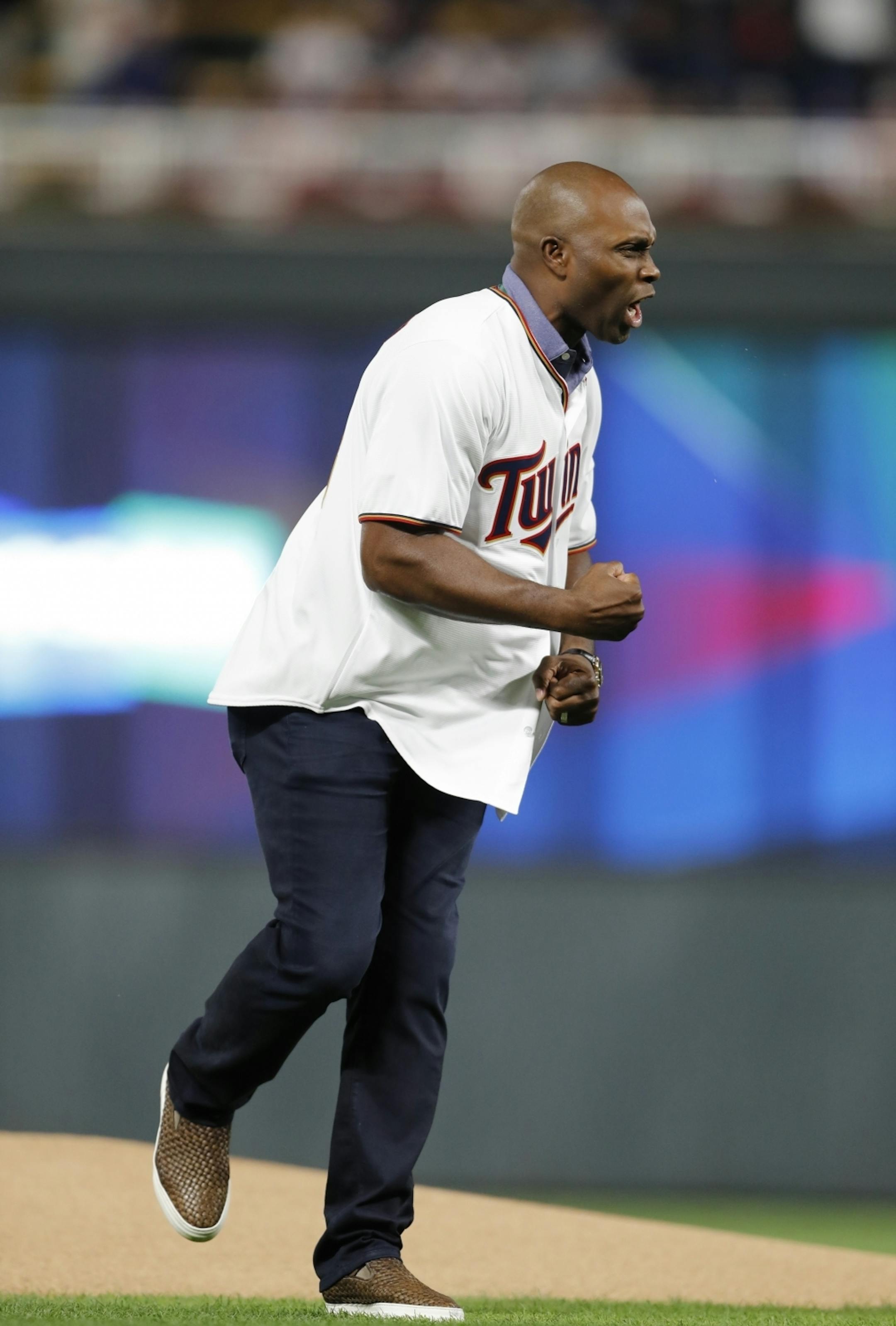 Former Twin Torii Hunter reacted after throwing out the first pitch before the start of Game 3.