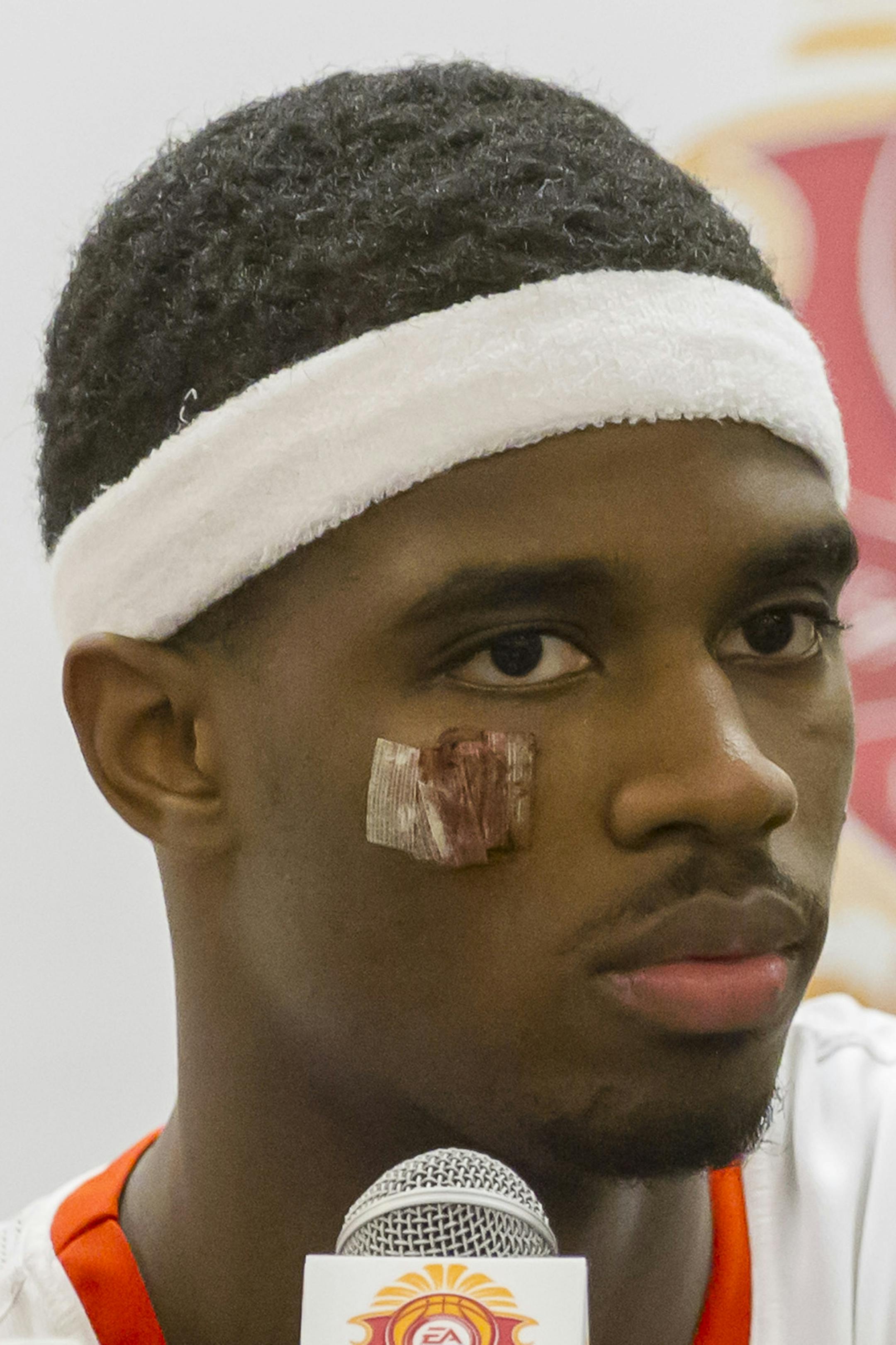 Syracuse forward C.J. Fair (5) addresses the media during the post game press conference after a NCAA college basketball game at the Maui Invitational on Monday, Nov. 25, 2013, in Lahaina, Hawaii. Syracuse defeated Minnesota 75-67. Fair was injured during the game. (AP Photo/Eugene Tanner)