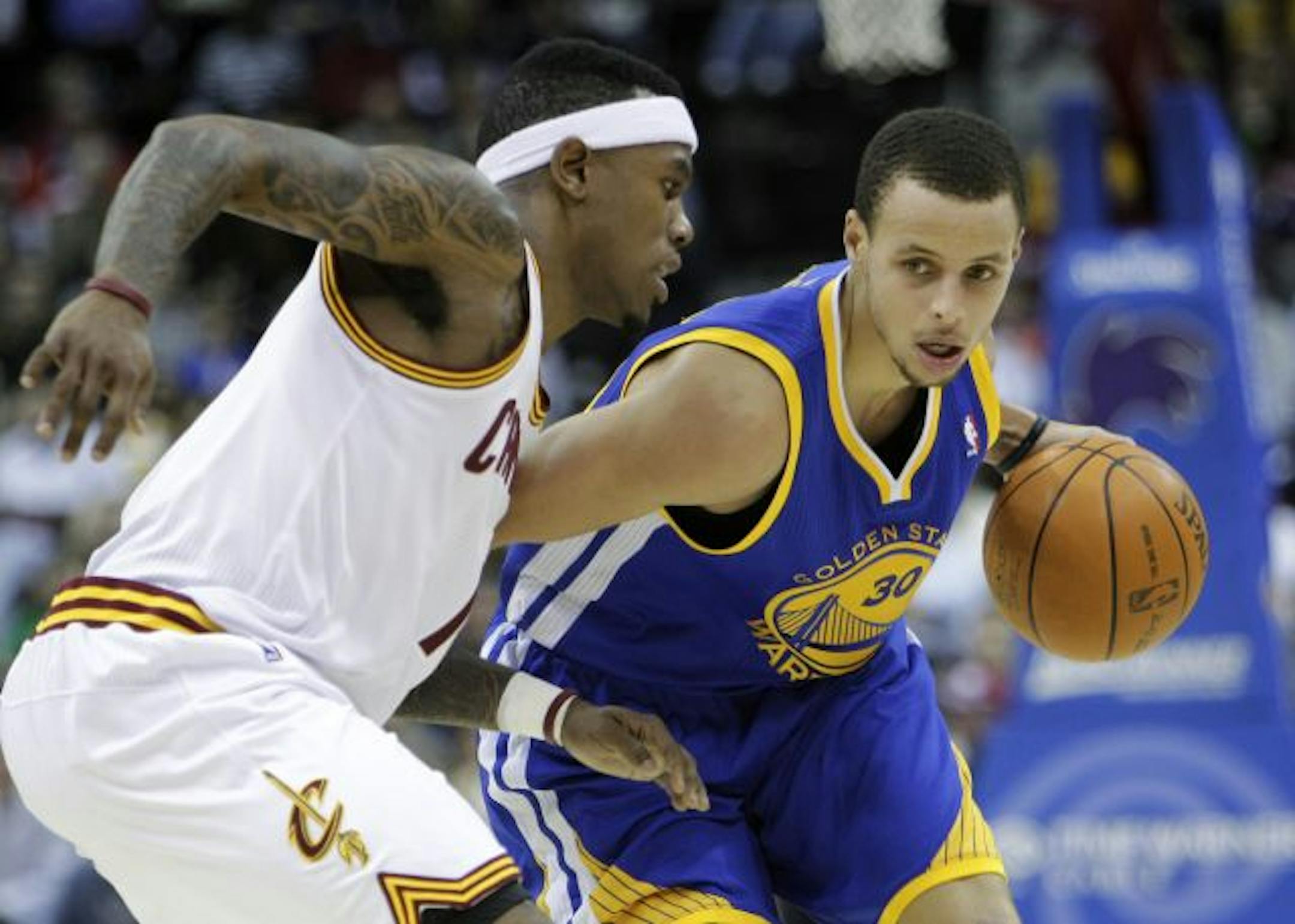 Golden State Warriors' Stephen Curry, right, tries to get past Cleveland Cavaliers' Daniel Gibson in the fourth quarter of an NBA basketball game Tuesday, March 8, 2011, in Cleveland. Curry scored 23 points in the Warriors' 95-85 win.