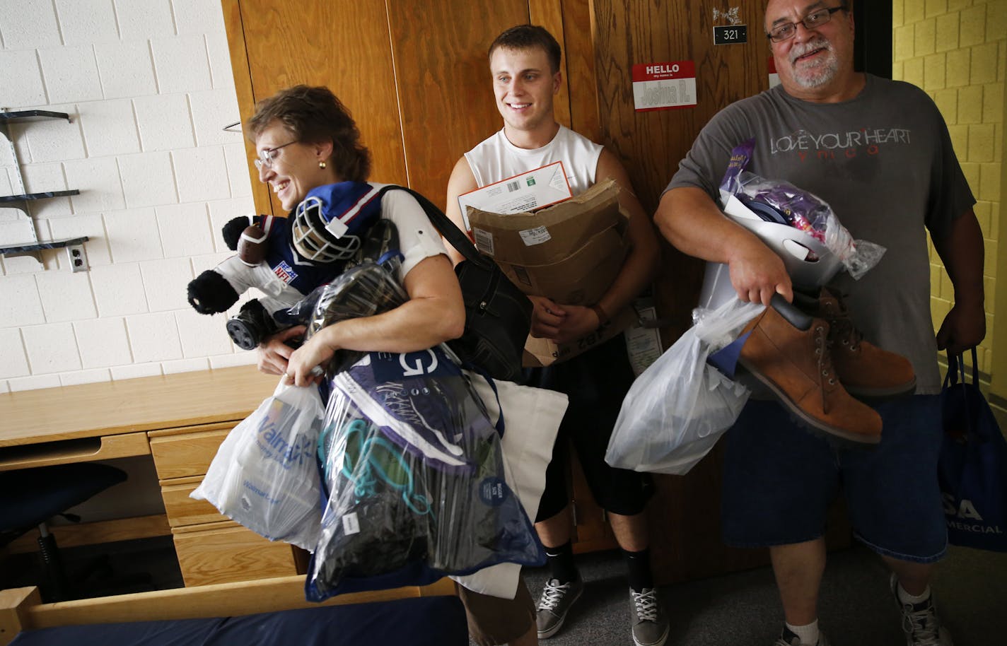 At Concordia College in St. Paul where tuition was cut by 30% to 19,000 this year,Carrie Reber, son Josh, and husband Steve all brought up Josh's stuff into Wollaeger Hall. Carrie and Steve met at Concordia when they went to school there. ]tsong-taataarii@startribune.com