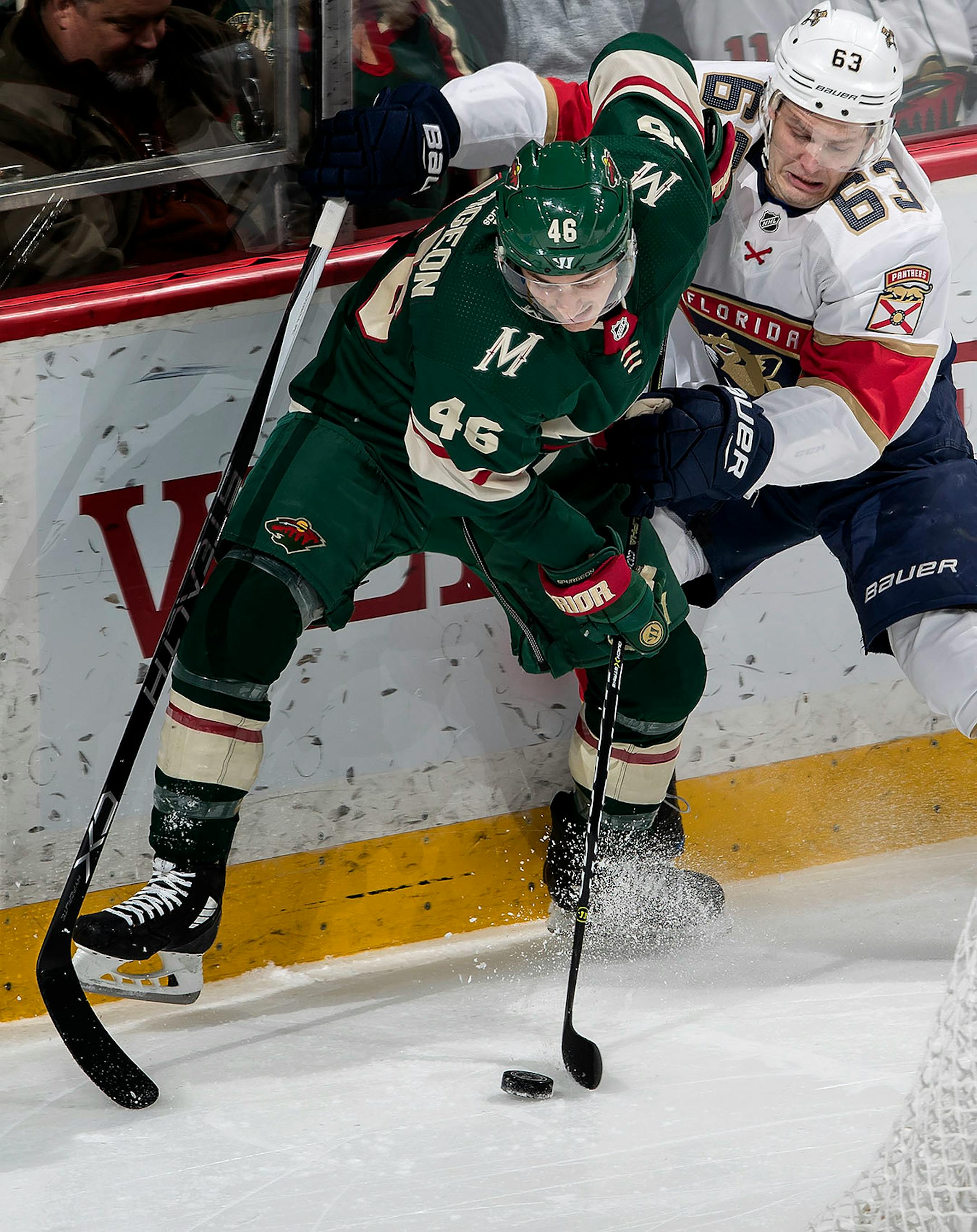 Jared Spurgeon (46) and Evgeni Dadonov (63) fought for the puck in the second period.
