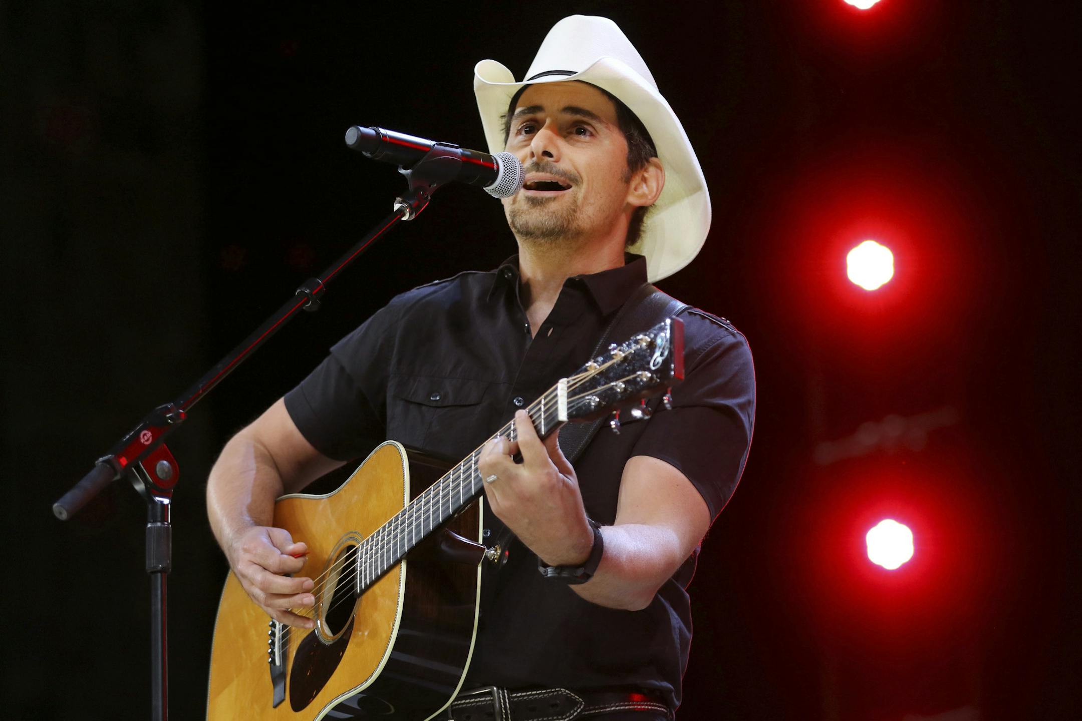 FILE - In this June 2, 2017 file photo, Country music recording artist Brad Paisley performs at the graduation for Barrington High School, at Willow Creek Community Church in South Barrington, Ill. Paisley says years of hosting the Country Music Awards and writing songs with humorous lyrics have - hopefully - prepared him to host his first comedy special, the ìBrad Paisley Comedy Rodeo,î which will premiere on Netflix on Tuesday, Aug. 15. (Steve Lundy /Daily Herald via AP, File)