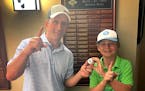 Ricardo Fernandez and 13-year-old Preston Miller held the ball they both used for an ace Thursday at Minneapolis Golf Club.