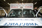 Paramedic Josh Anderson, right, and EMT Ryan Vierzba prepare to depart in their ambulance for a shift in February 2022 at the Allina Health EMS South 