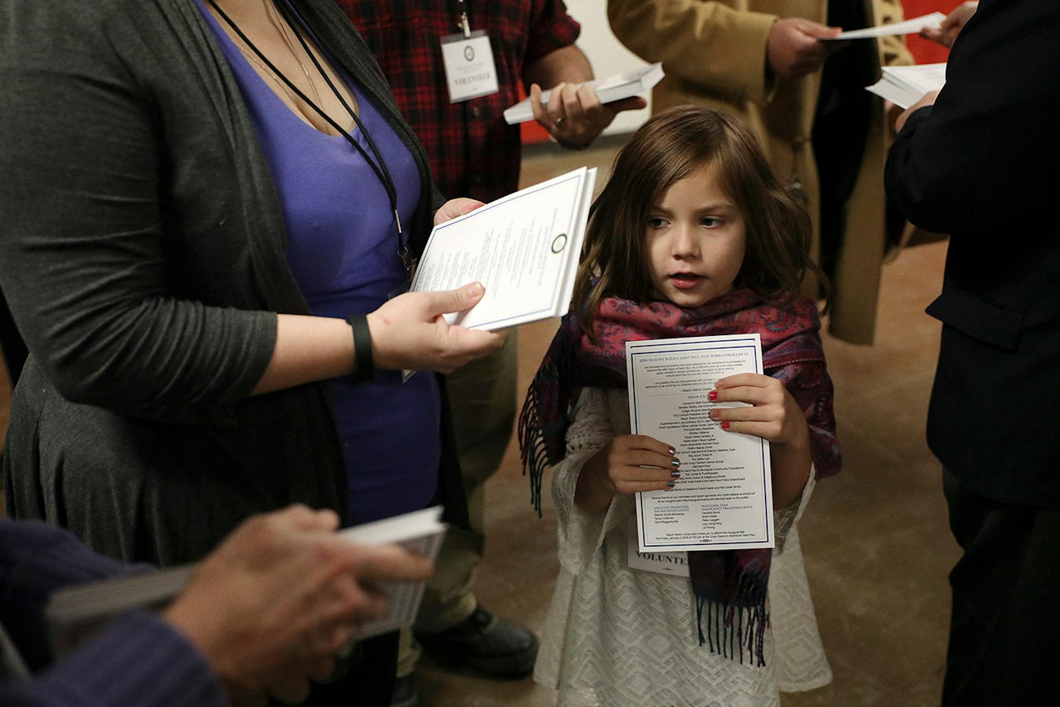 A group of volunteers waited to pass out programs prior to Melvin Carter's swearing in ceremony as St. Paul mayor.